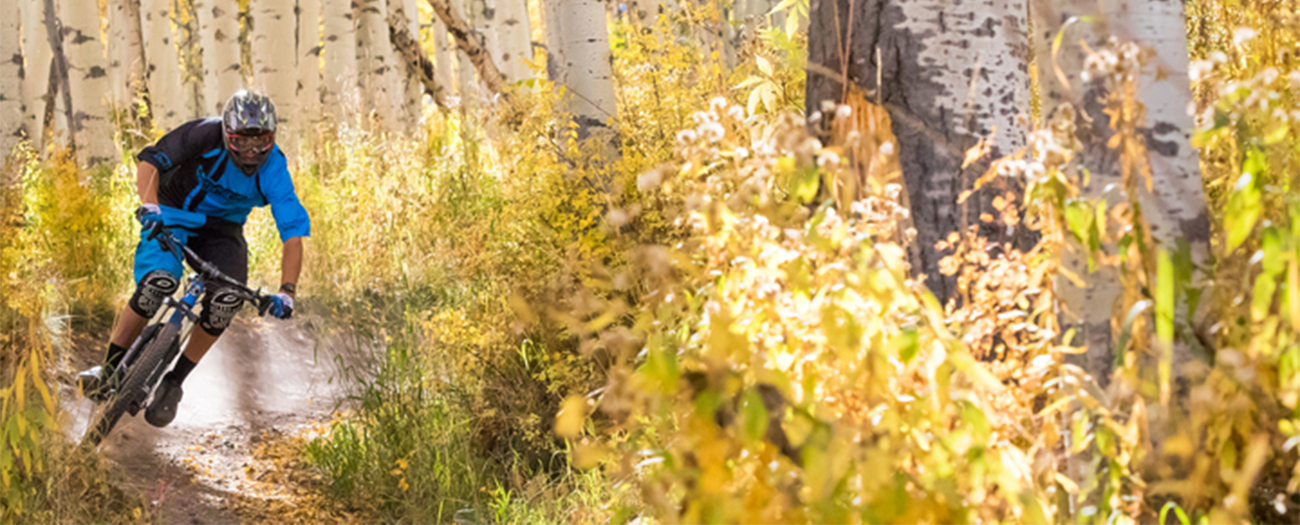 Mountain Biker going fast downhill on Snowmass