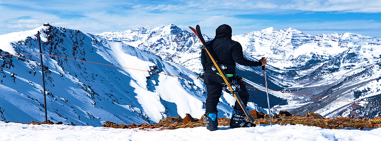 Man Uphill skiing on Highlands Mountain on the Bowl in Aspen, Colorado