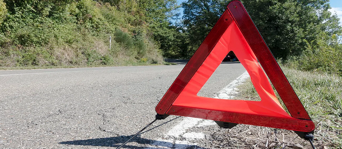 caution sign on side on road 