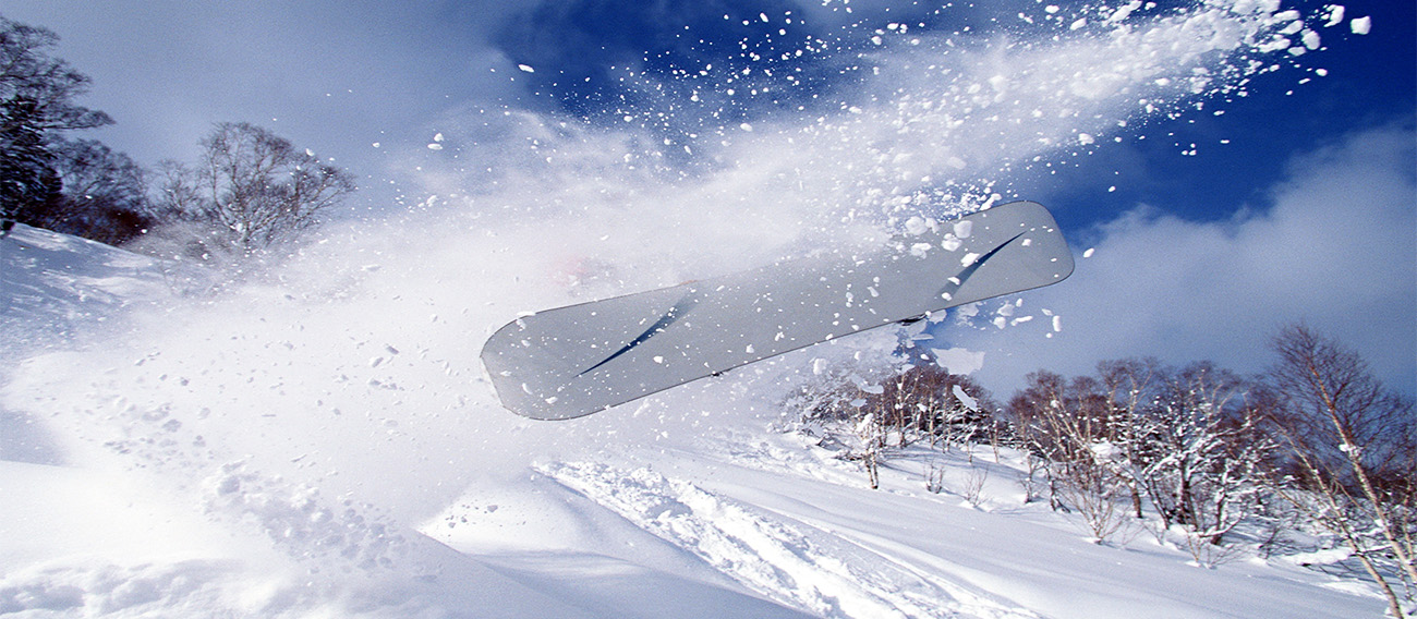 Man snowboarding in deep snow Backcountry skiing on Snowmass Mountain Snowmass, Colorado