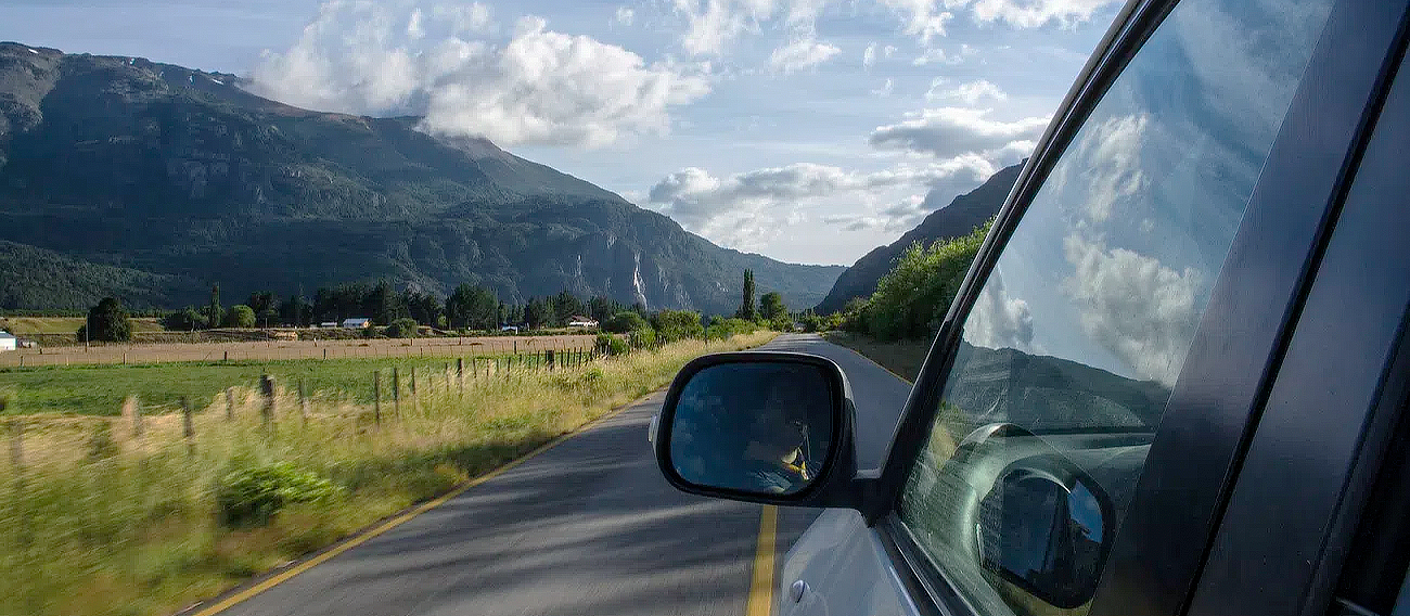 car traveling car driving to Aspen next to open fields