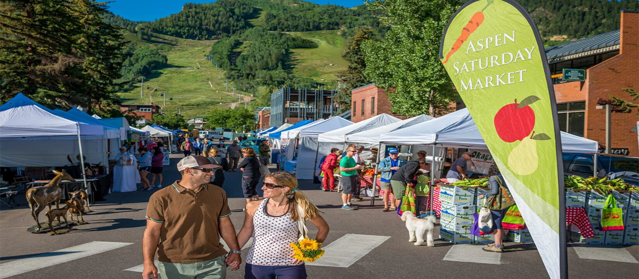 Saturday market during busy summer day with happy couple