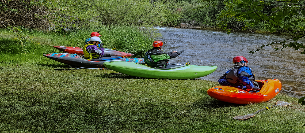 Group of Kayakers sitting on the bank of the Rio Grande River in Aspen, Colorado in July 2024